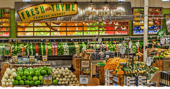 The inside of a grocery store filled with fruits and vegetables.