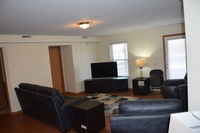 A living room filled with furniture and a flat screen TV.