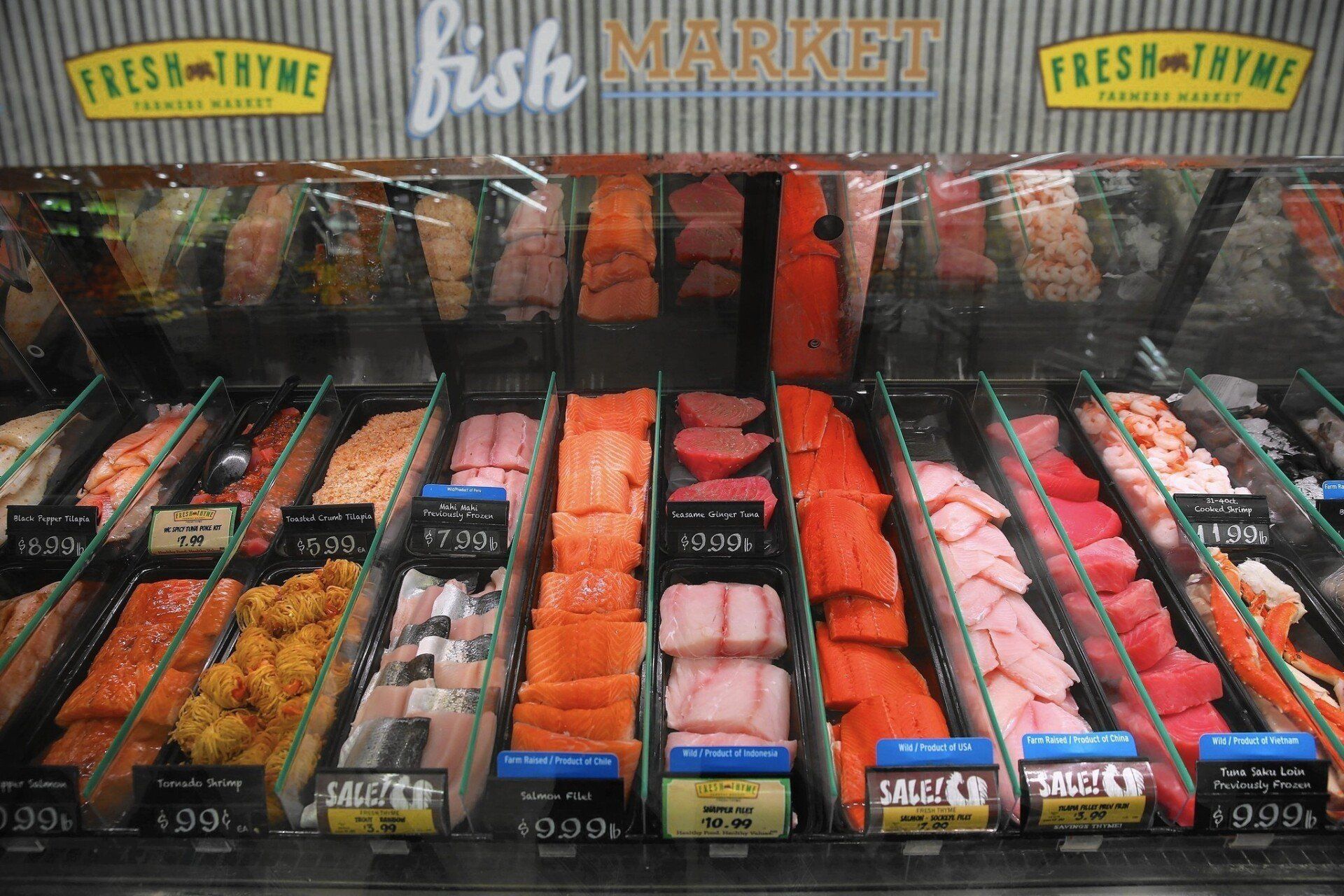 A variety of fish is on display at a fish market.