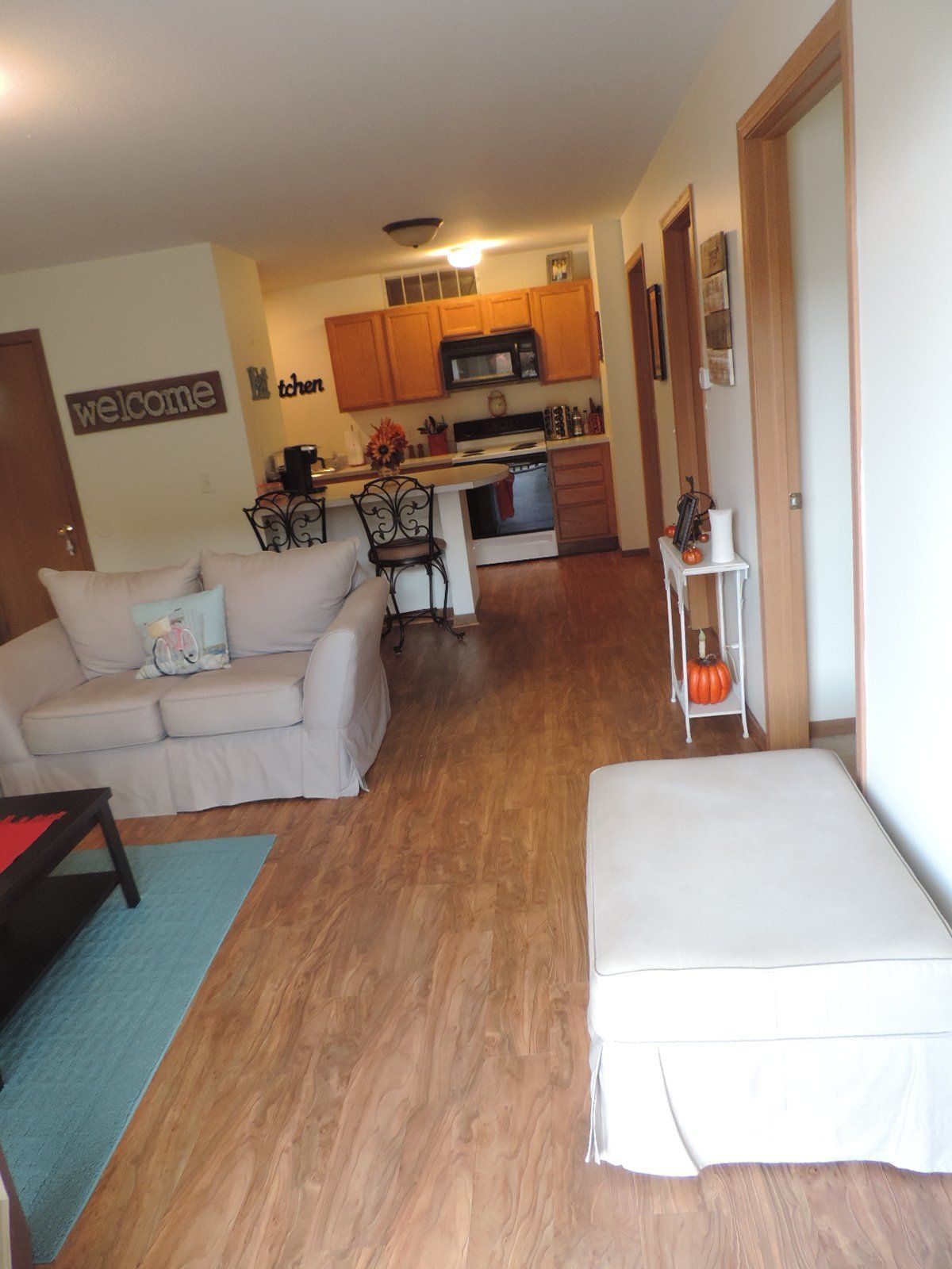 A living room with a sign that says welcome.