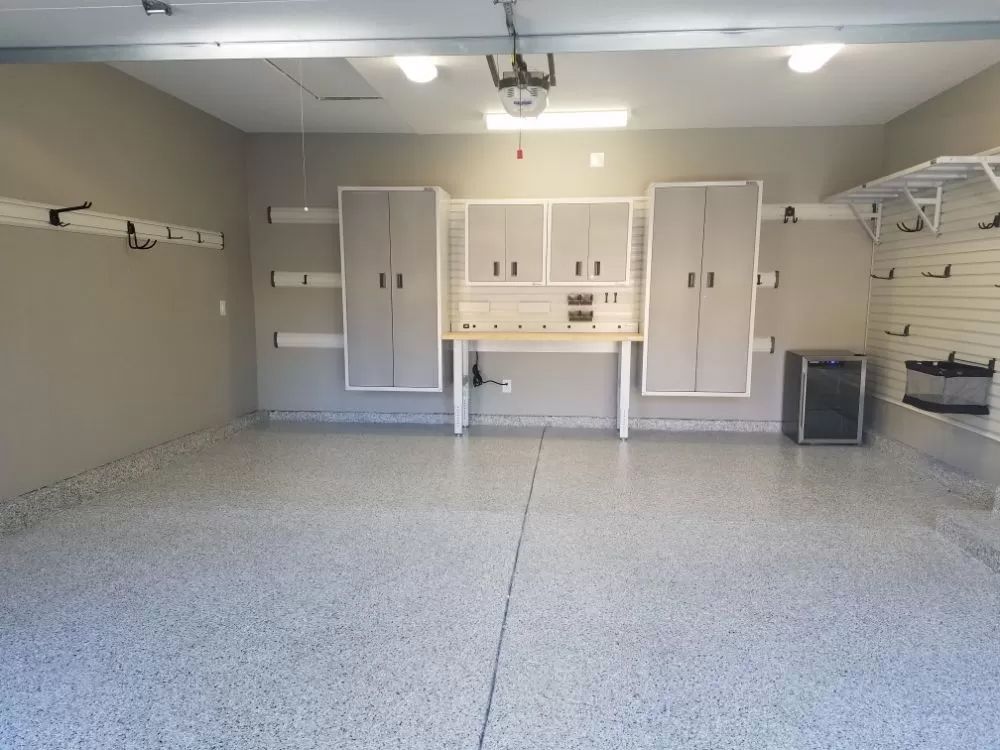 A large empty garage with lots of cabinets and shelves.