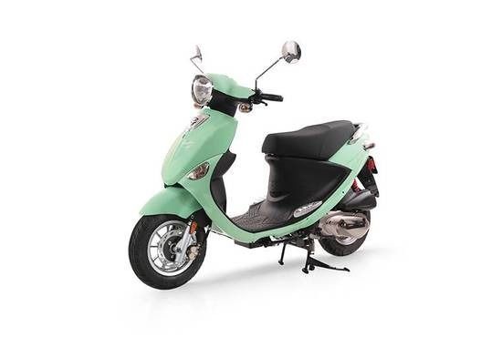 A mint green, retro-style gas scooter parked on its kickstand against a white background.
