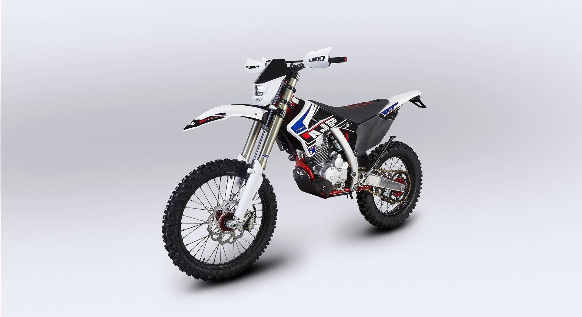 A white, black, and blue motocross motorcycle shown from a three-quarter front angle against a plain grey background.