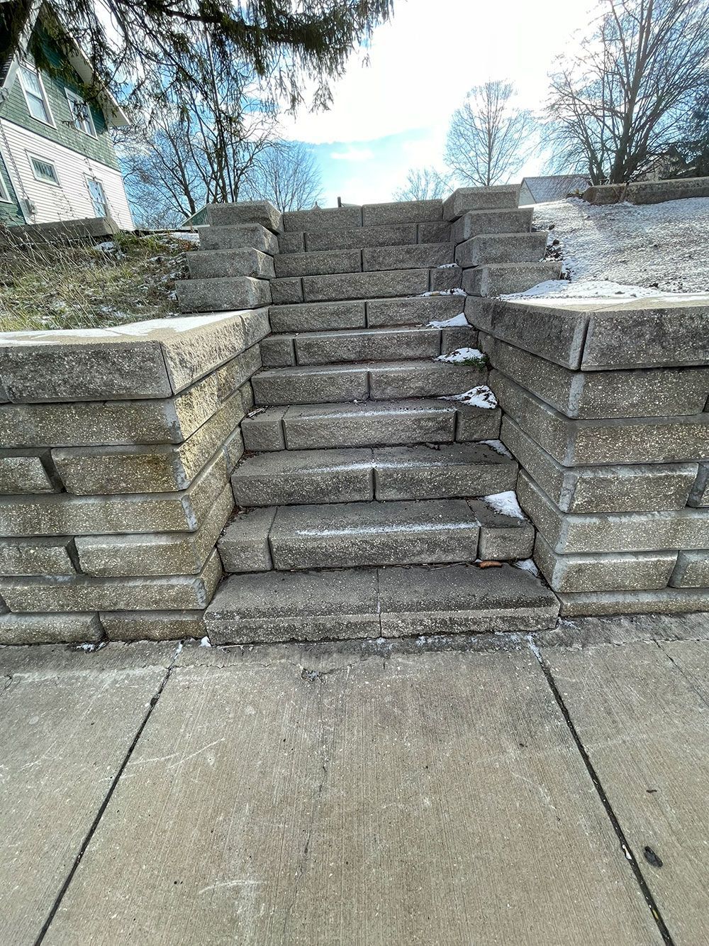 A set of stairs leading up to a stone wall.