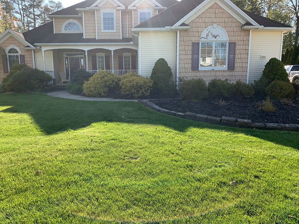 A large house with a lush green lawn in front of it
