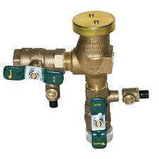 A brass valve with two green valves attached to it on a white background