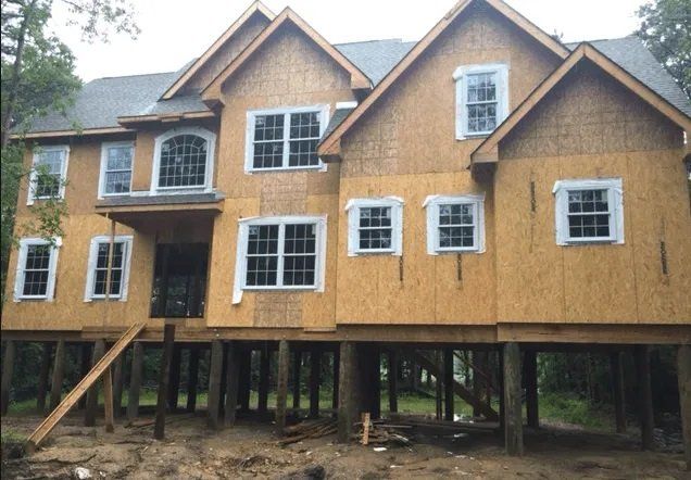 A large house that is being built on stilts