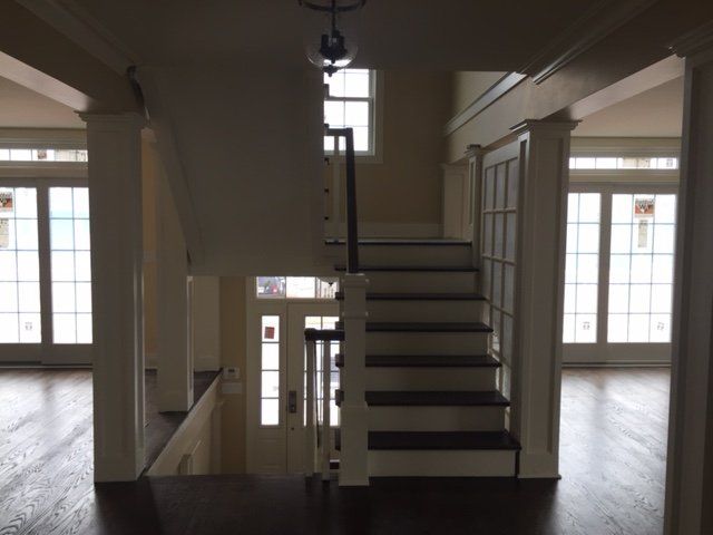 An empty house with stairs leading up to the second floor