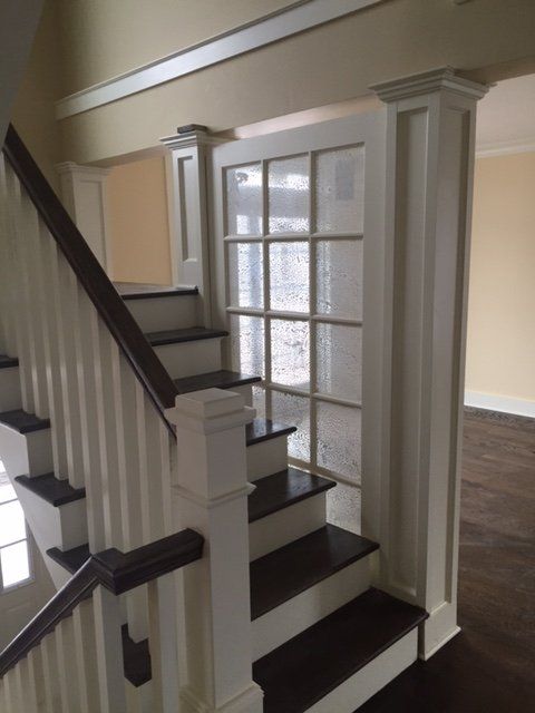 A staircase with a white railing and wooden steps