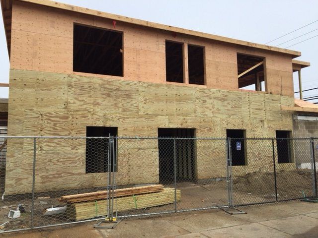 A building under construction with a fence around it