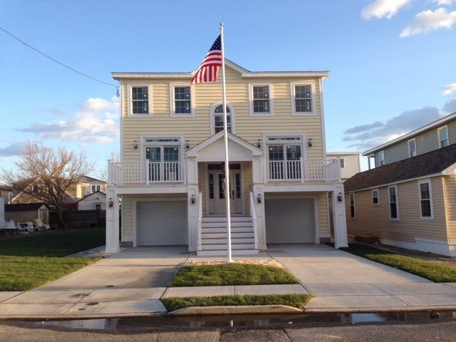 A large house with an american flag in front of it