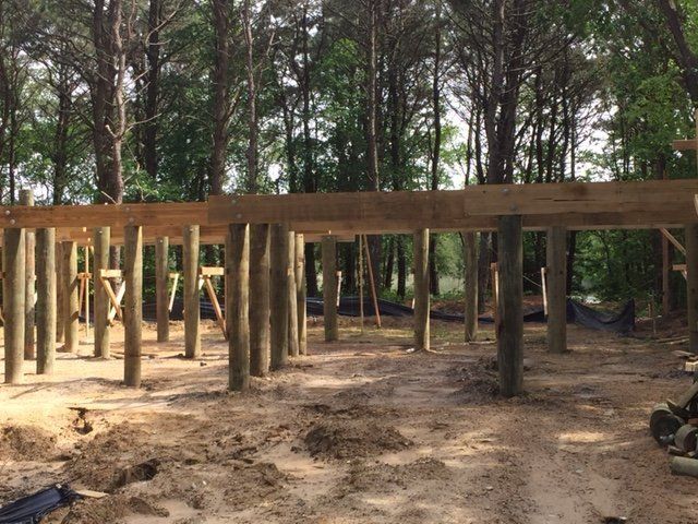 A wooden structure is being built in the middle of a wooded area
