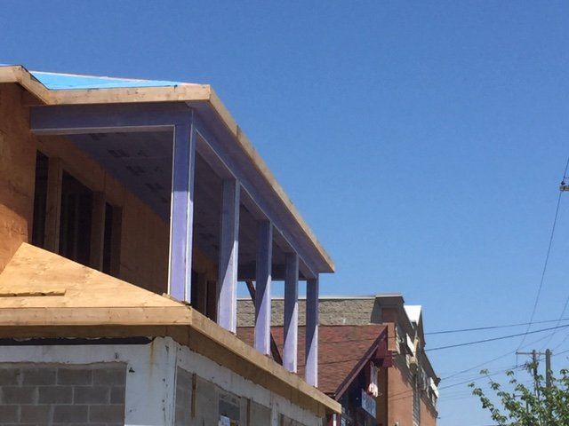 A building under construction with a blue sky in the background