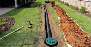 A drain pipe is being installed in a yard