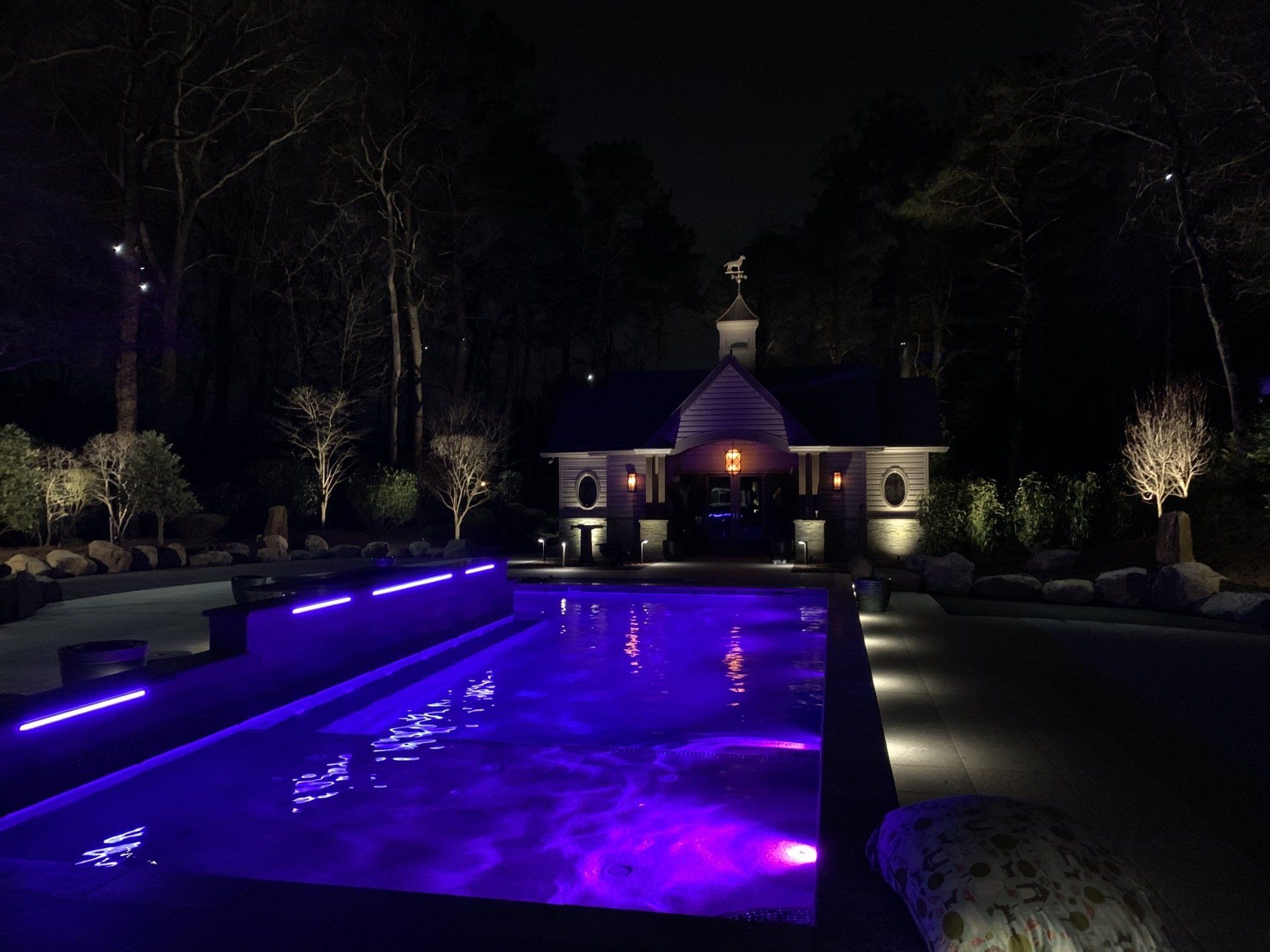 A large swimming pool with purple lights