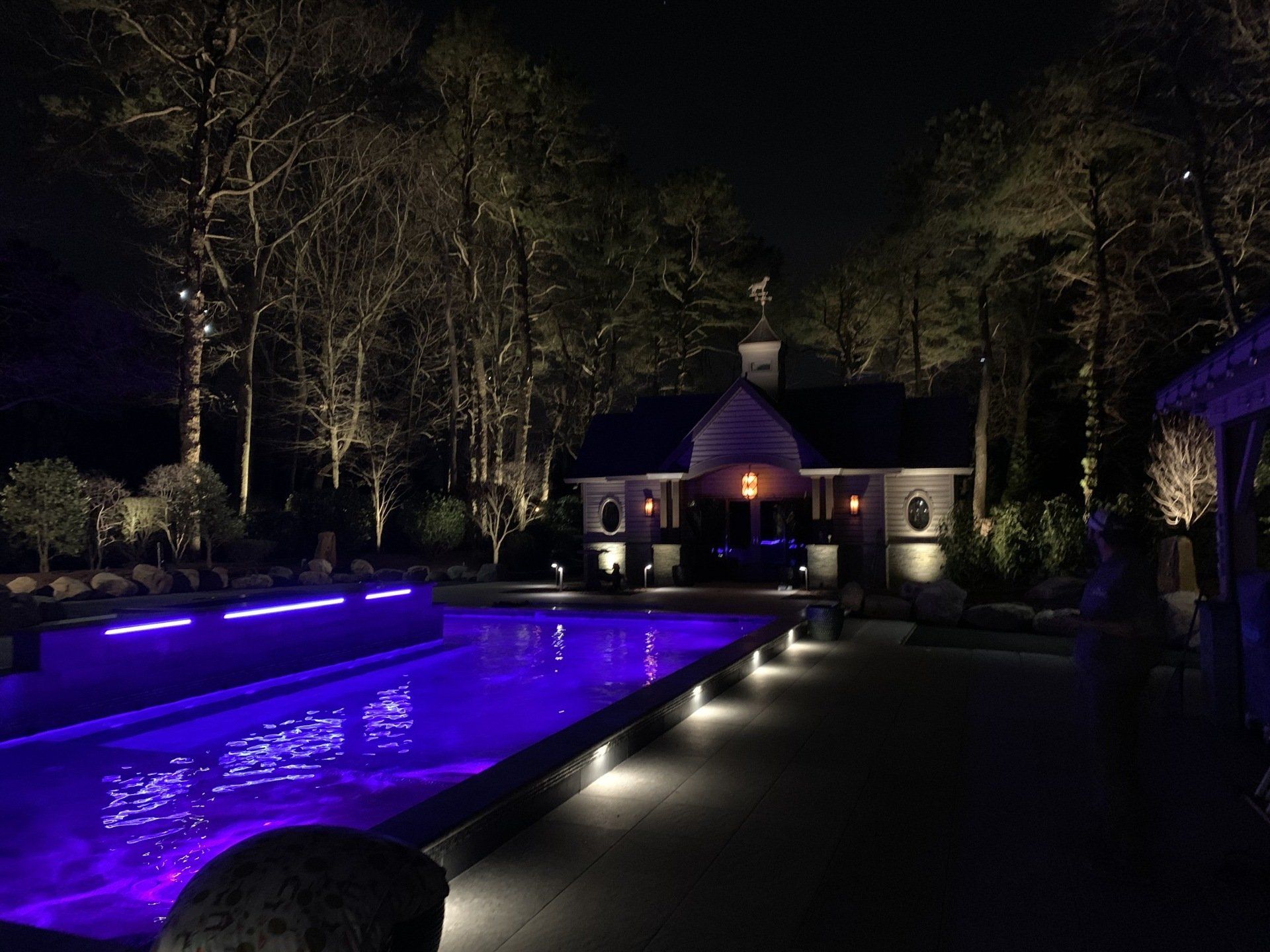 A large swimming pool with purple lights
