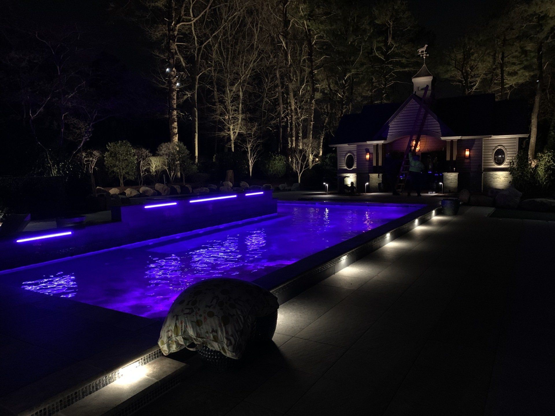 A large swimming pool with purple lights