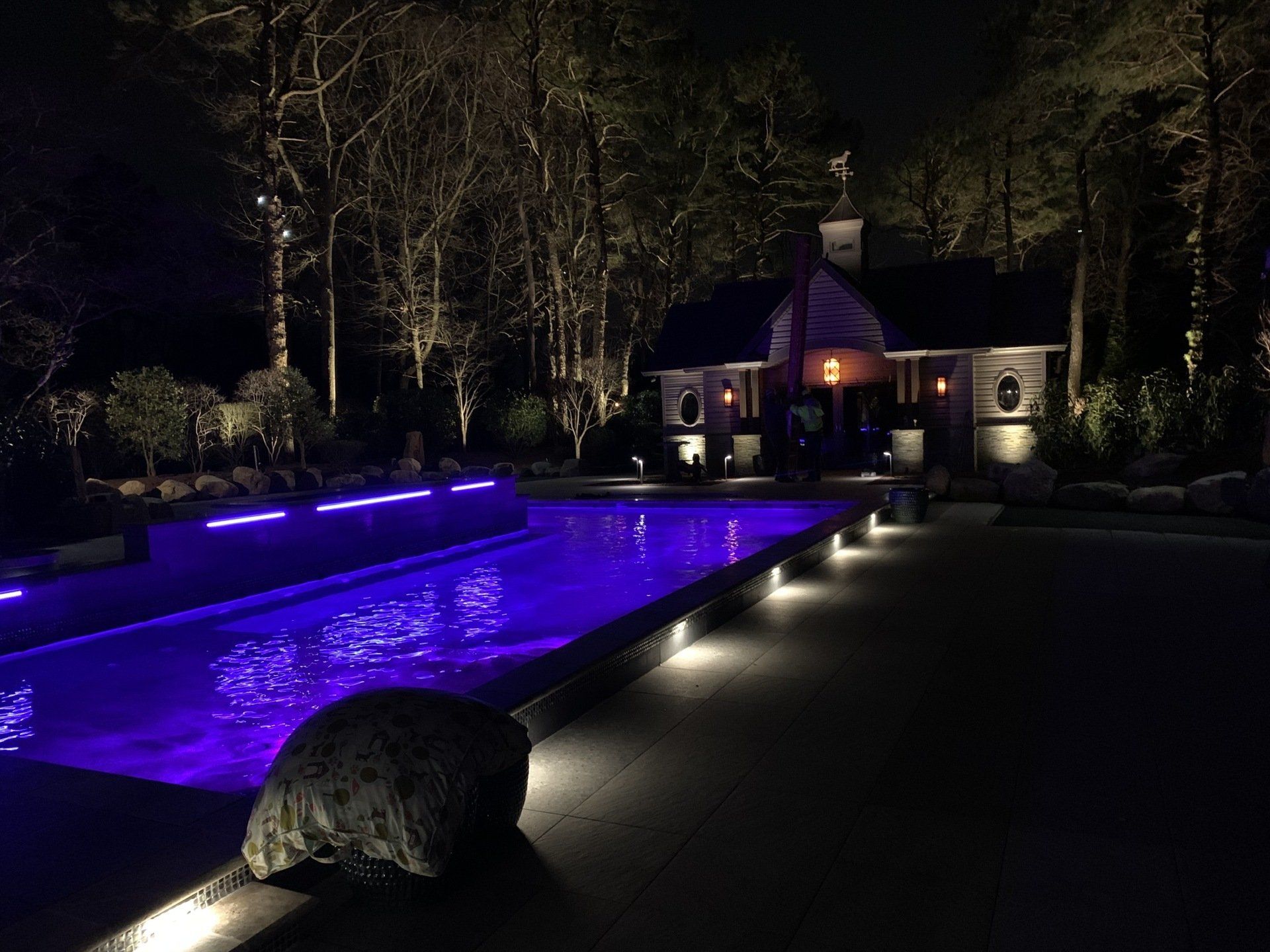 A large swimming pool with purple lights