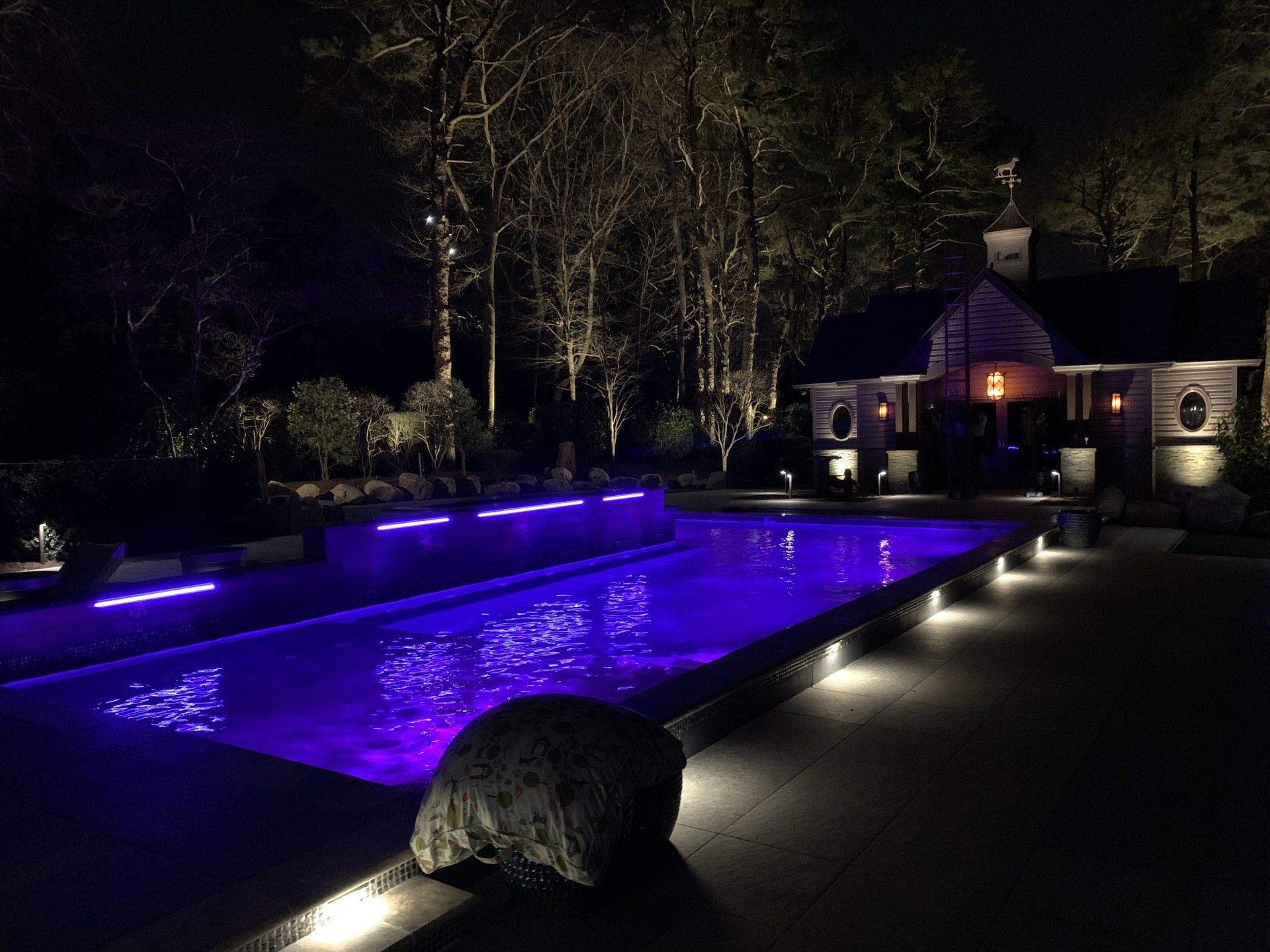 A large swimming pool with purple lights