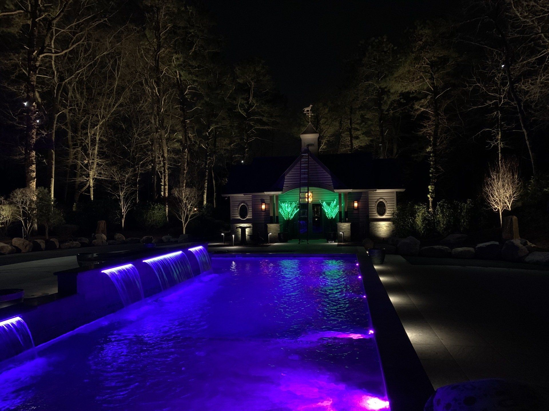A large swimming pool with purple lights