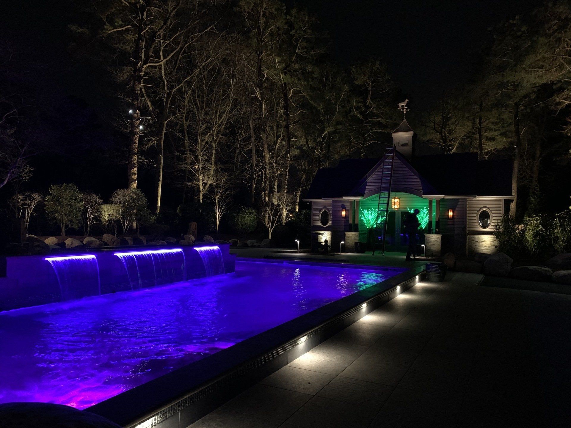 A large swimming pool with purple lights