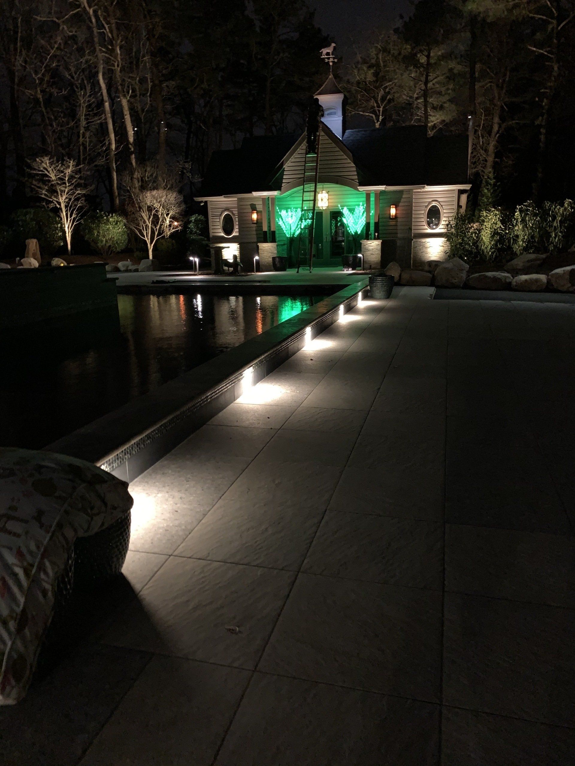A house with green lights is lit up at night