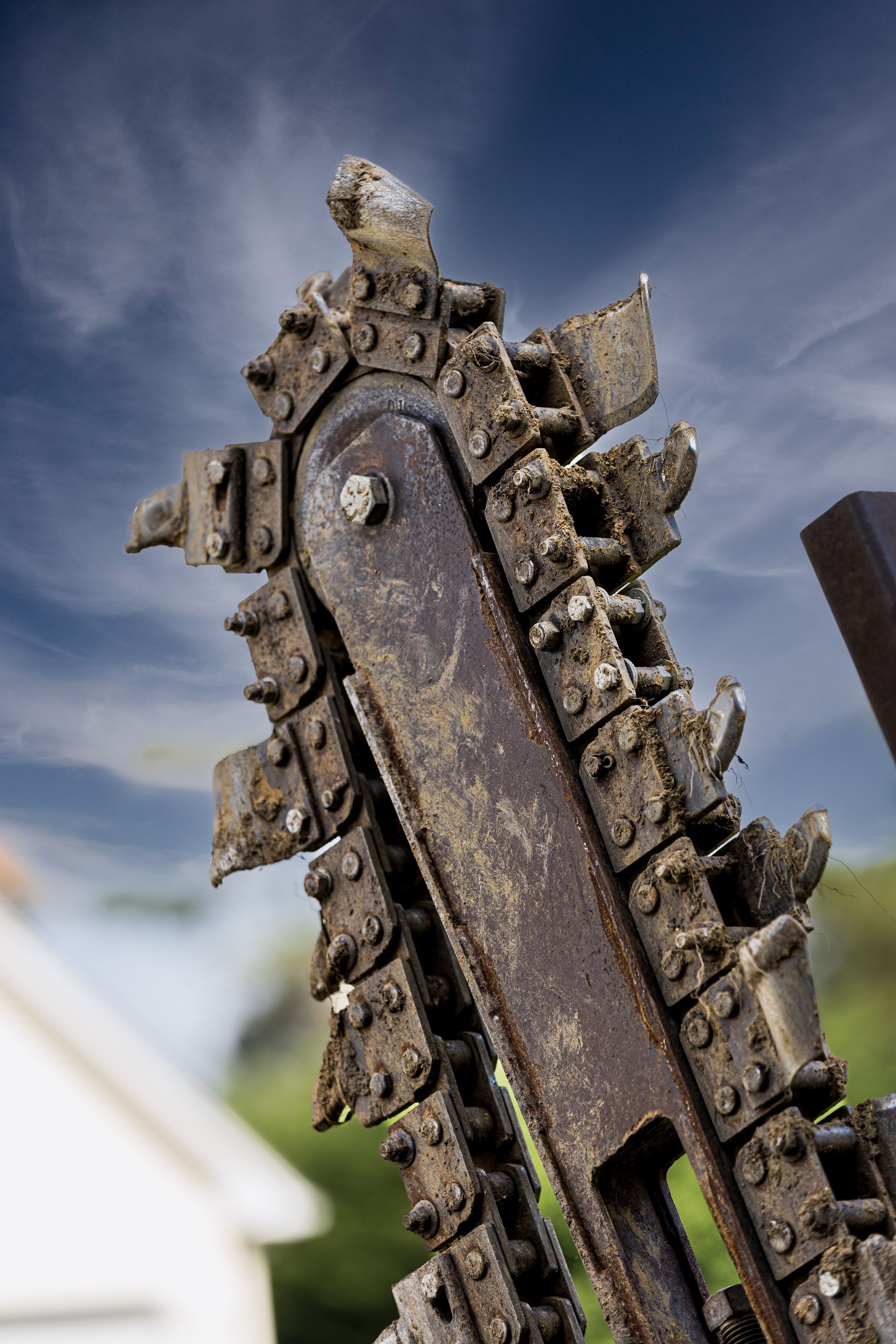 A close up of a trencher digging chain