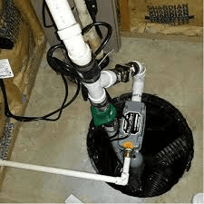 A sump pump is connected to a drain in a basement