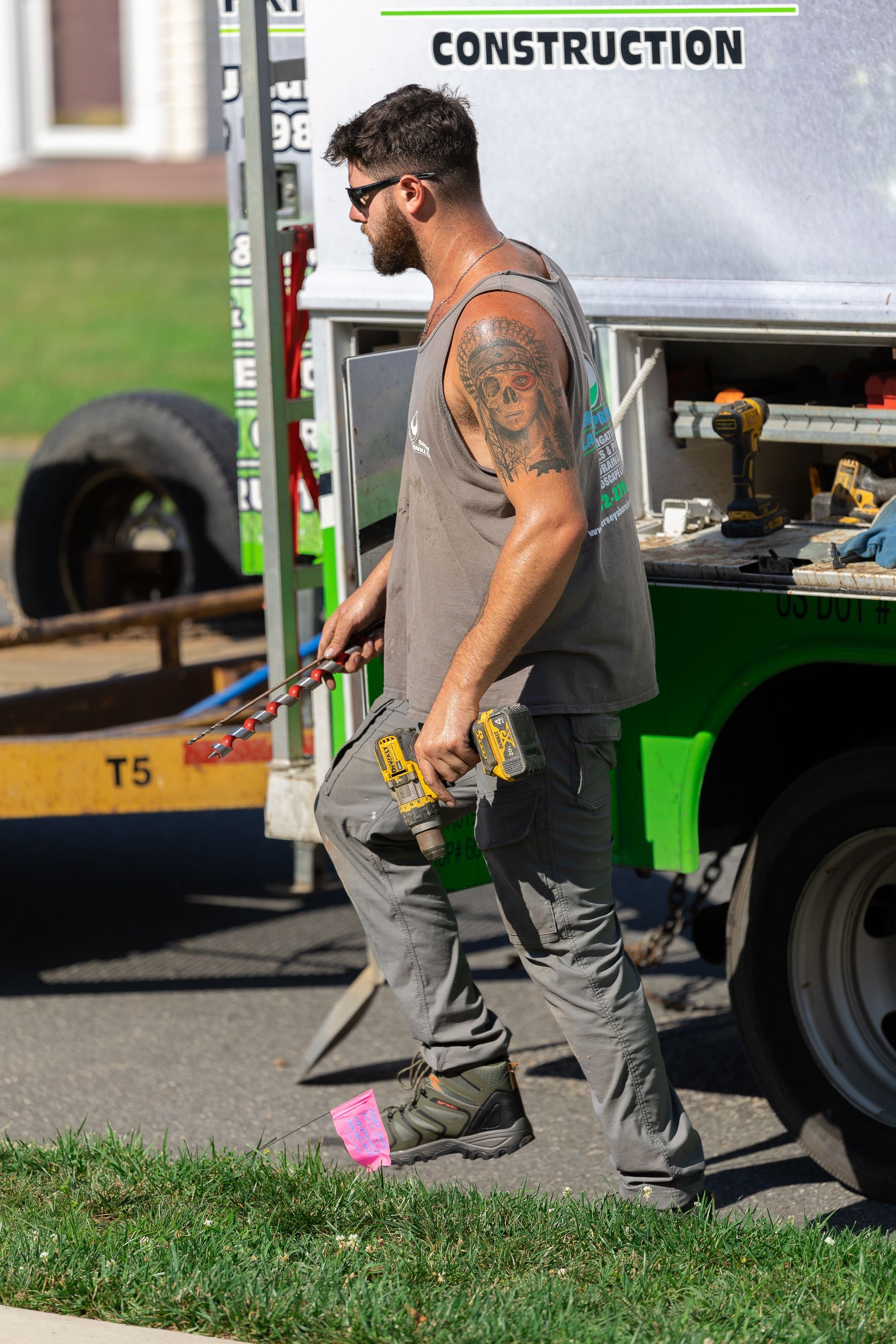 A man standing in front of a construction truck