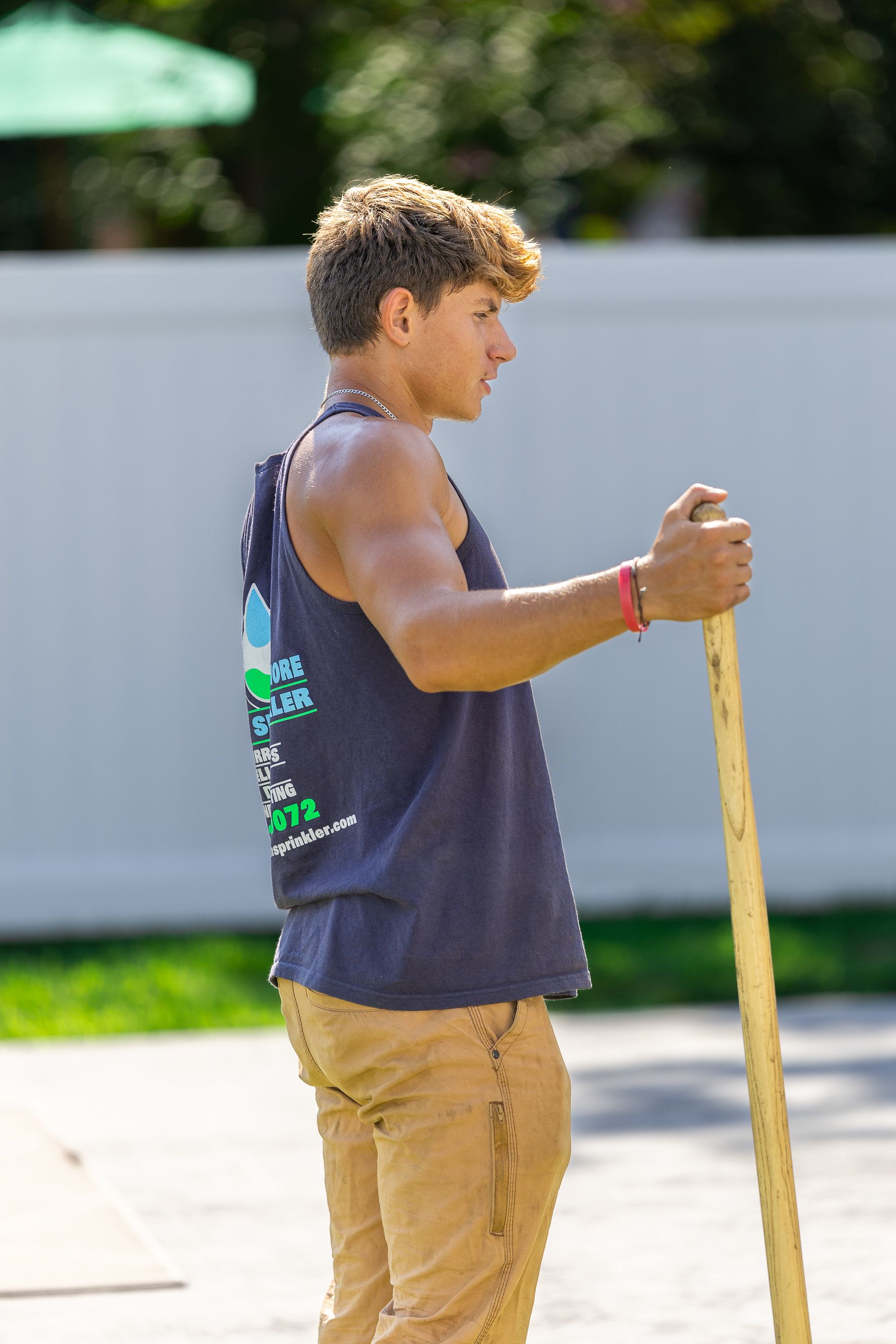 A man holding a wooden stick