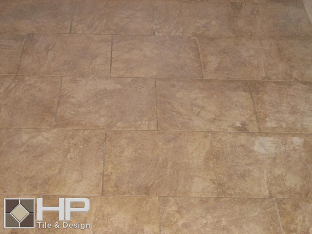 Tan stone tile flooring with grout lines