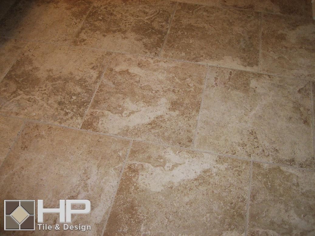 Beige and brown marble floor tiles with visible veining and natural variations