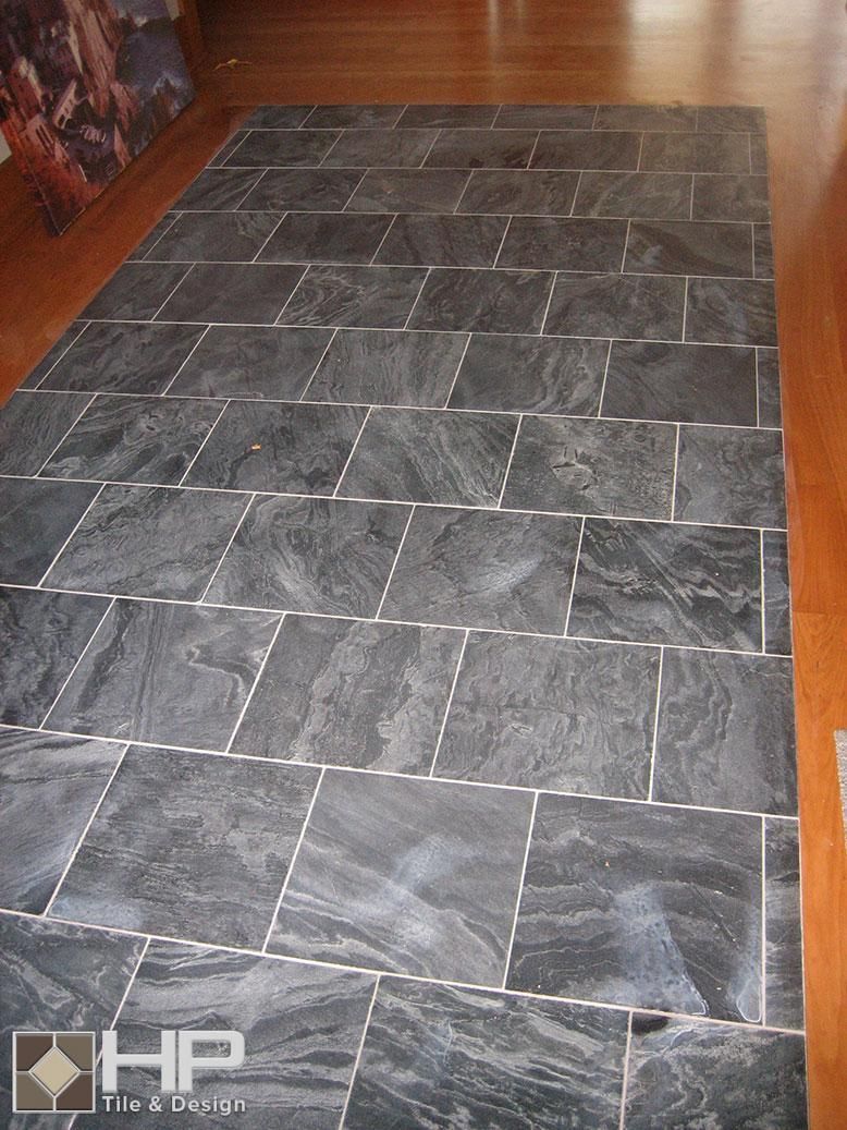 Black slate tile flooring on hardwood