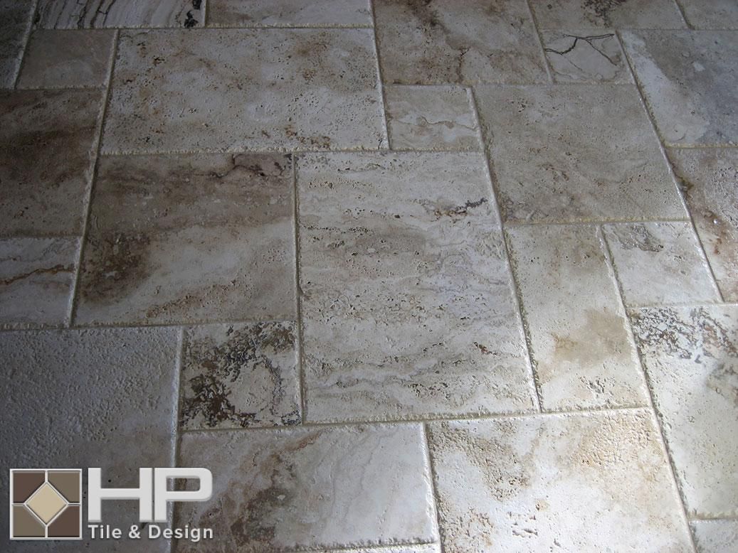 Beige and brown travertine tile flooring in a random pattern