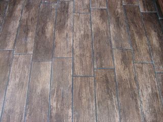 Dark brown wood-look flooring with rectangular planks and visible grain patterns.