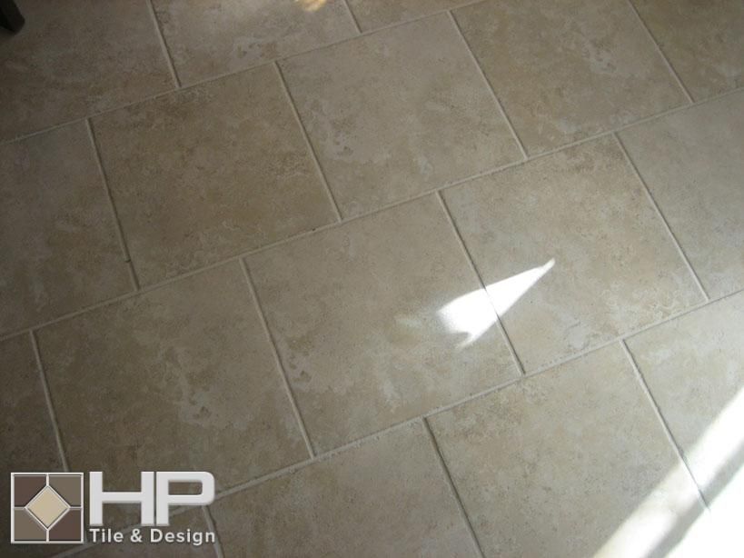 Beige rectangular tile floor with sunlight and shadow