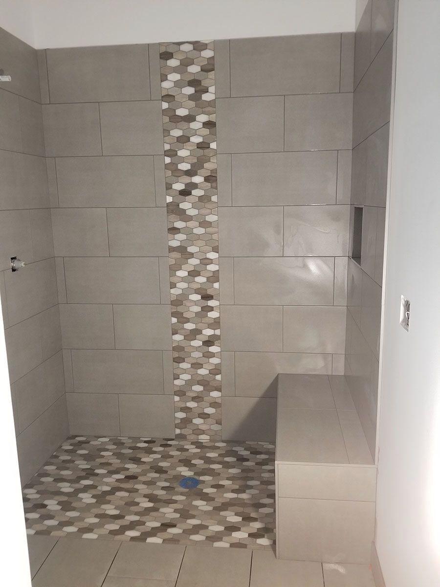 Bathroom with tiled shower and bench