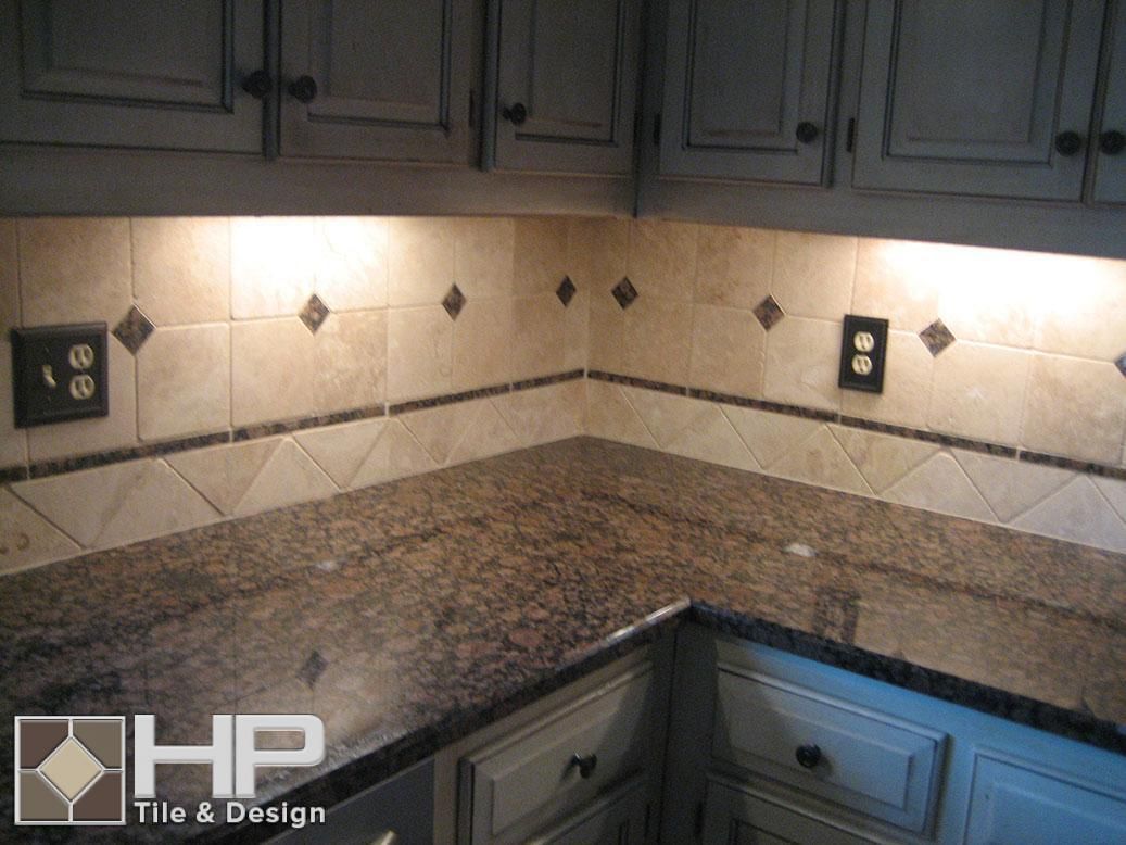 Kitchen with granite countertops, tile backsplash, and under-cabinet lighting.