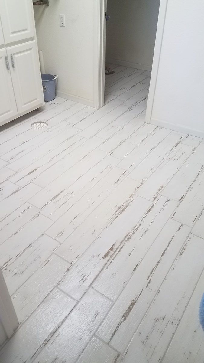White-painted wood-look tile floor in a room