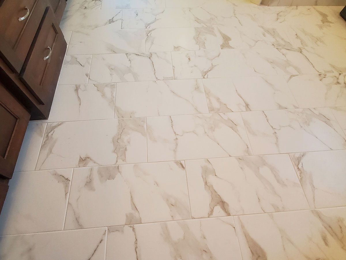 White marble-patterned tile flooring in a kitchen