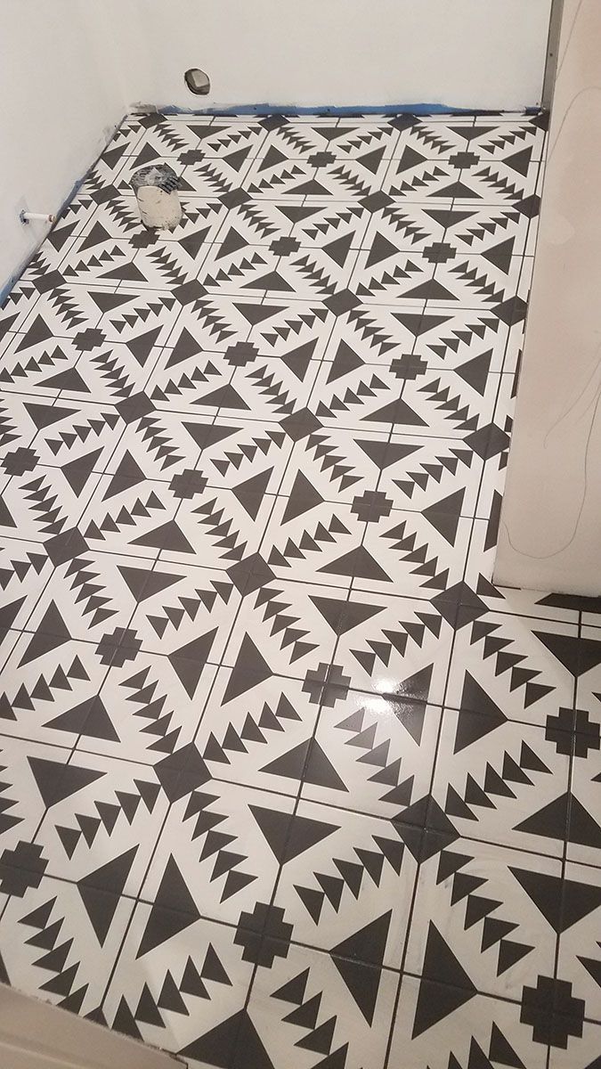 Black and white patterned tile flooring in a bathroom