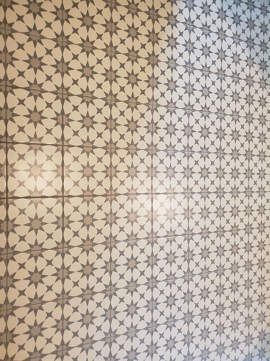 White and gray patterned tile flooring with star-like designs
