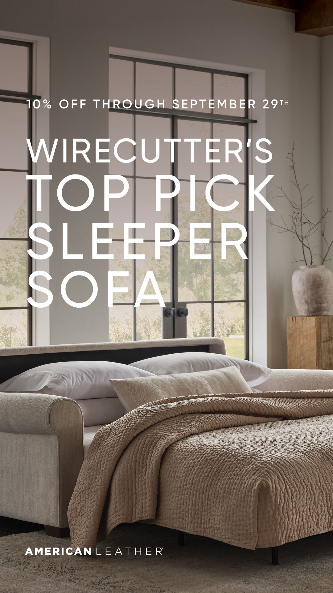 Living room with a beige sleeper sofa and text overlay “Wirecutter’s Top Pick Sleeper Sofa”