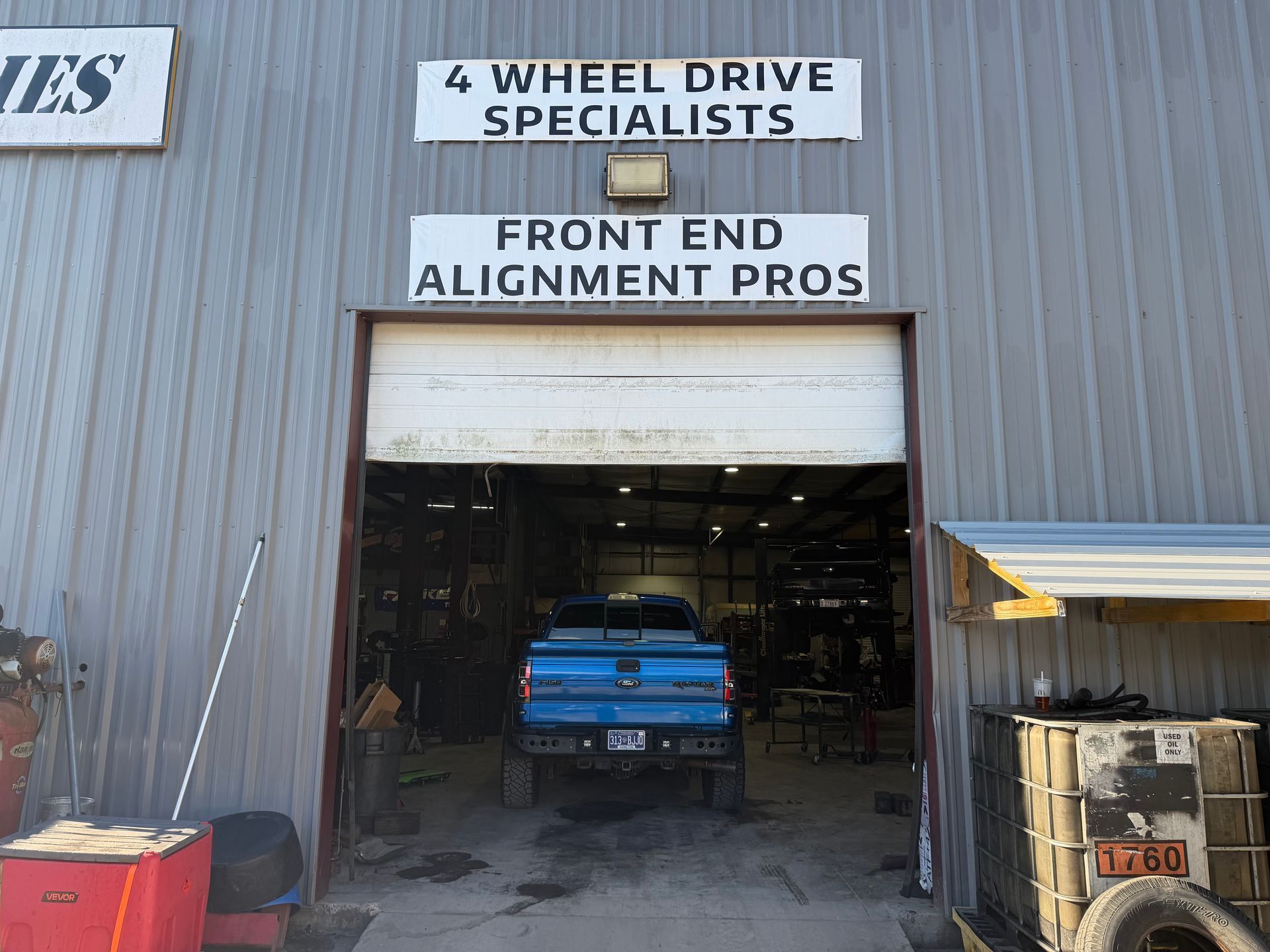 Blue truck inside 4 Wheel Drive Specialists front end alignment shop entrance