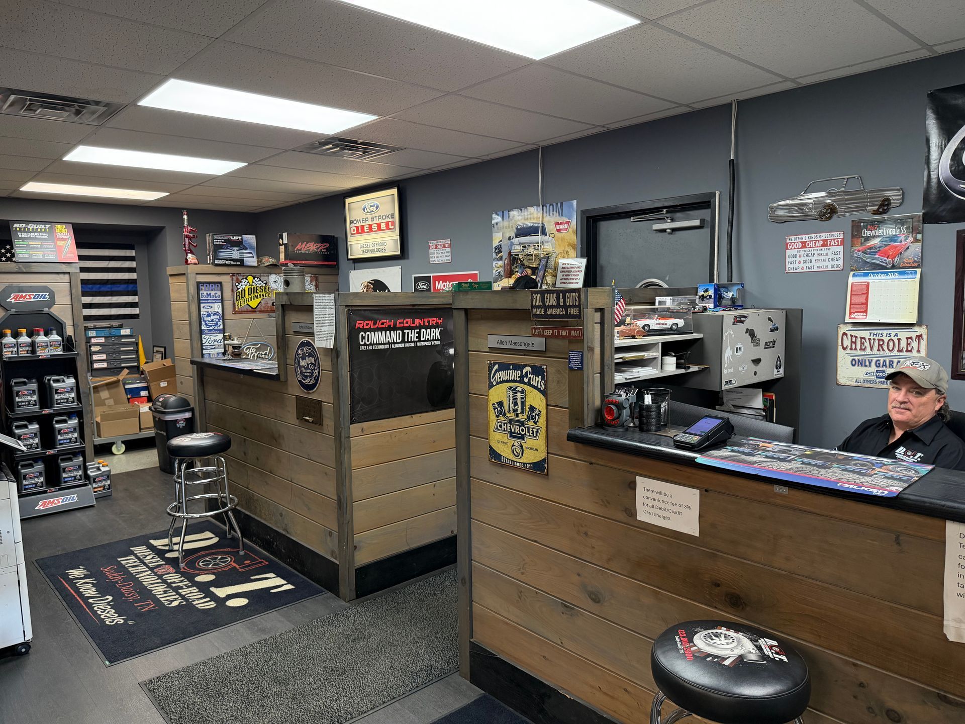 Auto parts store interior with counters, displays, and a cashier sitting at the register