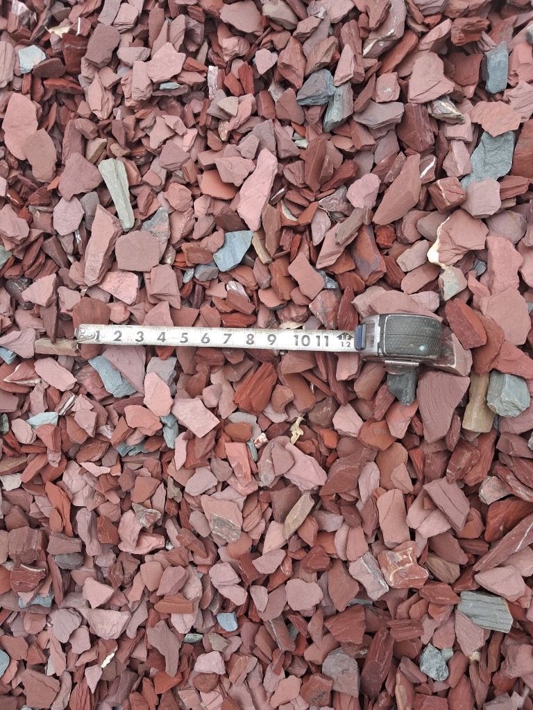 A pile of red gravel is sitting on top of each other.