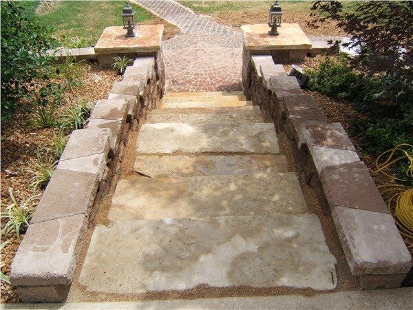 A set of stairs made out of stone in a garden