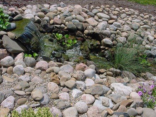 A rock garden with a waterfall in the middle