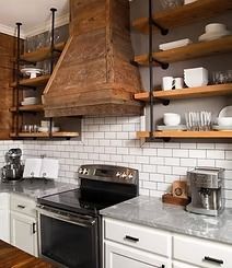 Kitchen with exposed shelving, a wooden range hood, white subway tile, and countertop appliances.