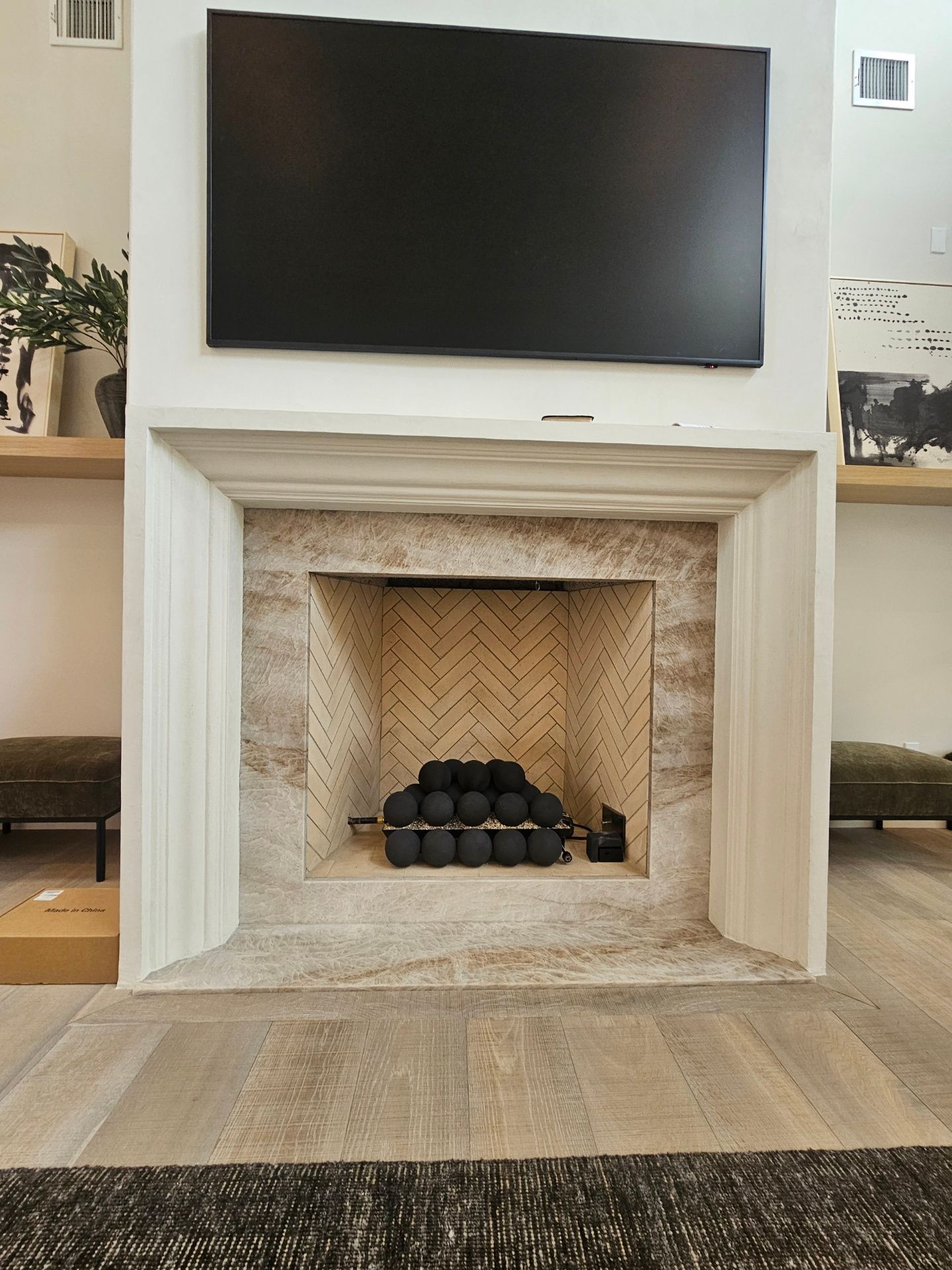 A fireplace with a flat screen tv above it